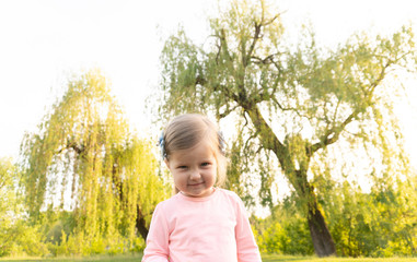 Funny angry face of little cute girl looking in camera