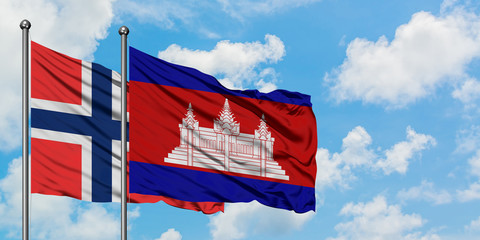 Bouvet Islands and Cambodia flag waving in the wind against white cloudy blue sky together. Diplomacy concept, international relations.