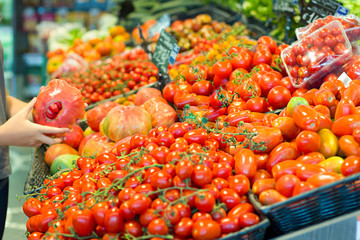 Female hand choosing vegetables in the market