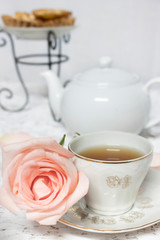 tea time with rose flower and dessert