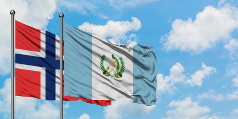 Bouvet Islands and Guatemala flag waving in the wind against white cloudy blue sky together....
