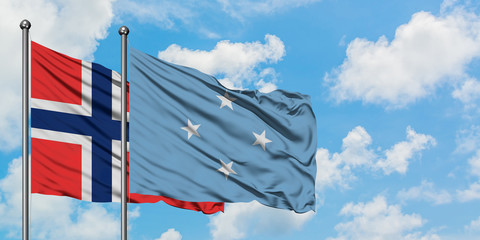 Bouvet Islands and Micronesia flag waving in the wind against white cloudy blue sky together. Diplomacy concept, international relations.