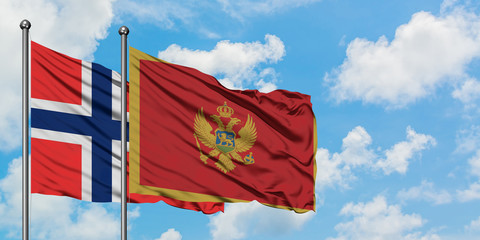 Bouvet Islands and Montenegro flag waving in the wind against white cloudy blue sky together. Diplomacy concept, international relations.