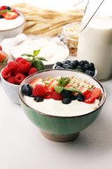 Tasty homemade granola served on table. Healthy breakfast with a bowl of oatmeal with banana, blueberries, strawberries and healthy food for Breakfast