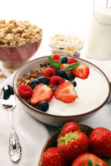 Tasty homemade granola served on table. Healthy breakfast with a bowl of oatmeal with banana, blueberries, strawberries and healthy food for Breakfast
