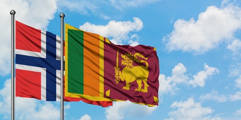 Bouvet Islands and Sri Lanka flag waving in the wind against white cloudy blue sky together. Diplomacy concept, international relations.