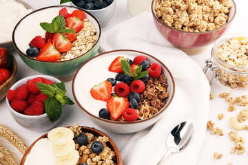 Tasty homemade granola served on table. Healthy breakfast with a bowl of oatmeal with banana, blueberries, strawberries and healthy food for Breakfast