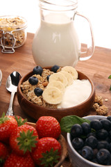 Tasty homemade granola served on table. Healthy breakfast with a bowl of oatmeal with banana, blueberries, strawberries and healthy food for Breakfast
