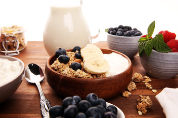 Tasty homemade granola served on table. Healthy breakfast with a bowl of oatmeal with banana, blueberries, strawberries and healthy food for Breakfast