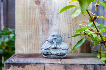 Thai style stone Buddha with praying hands