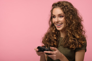 Pretty gamer girl on pink background