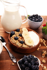 Tasty homemade granola served on table. Healthy breakfast with a bowl of oatmeal with banana, blueberries, strawberries and healthy food for Breakfast