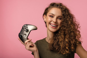 Pretty gamer girl on pink background © Anton Zabielskyi