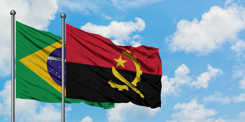Brazil and Angola flag waving in the wind against white cloudy blue sky together. Diplomacy concept, international relations.