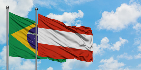 Brazil and Austria flag waving in the wind against white cloudy blue sky together. Diplomacy concept, international relations.