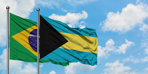 Brazil and Bahamas flag waving in the wind against white cloudy blue sky together. Diplomacy concept, international relations.