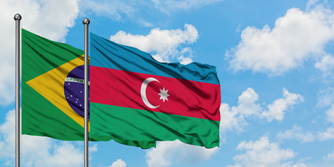 Brazil and Azerbaijan flag waving in the wind against white cloudy blue sky together. Diplomacy concept, international relations.