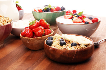 Tasty homemade granola served on table. Healthy breakfast with a bowl of oatmeal with banana, blueberries, strawberries and healthy food for Breakfast