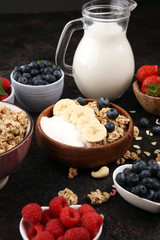 Tasty homemade granola served on table. Healthy breakfast with a bowl of oatmeal with banana, blueberries, strawberries and healthy food for Breakfast