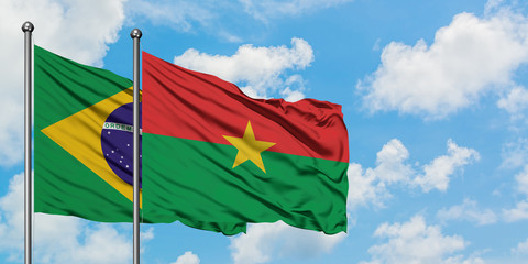 Brazil and Burkina Faso flag waving in the wind against white cloudy blue sky together. Diplomacy concept, international relations.