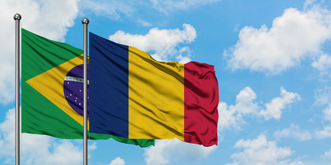 Brazil and Chad flag waving in the wind against white cloudy blue sky together. Diplomacy concept, international relations.