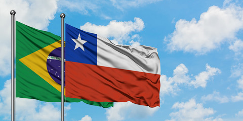 Brazil and Chile flag waving in the wind against white cloudy blue sky together. Diplomacy concept, international relations.