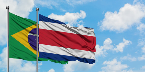 Brazil and Costa Rica flag waving in the wind against white cloudy blue sky together. Diplomacy concept, international relations.