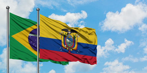 Brazil and Ecuador flag waving in the wind against white cloudy blue sky together. Diplomacy concept, international relations.