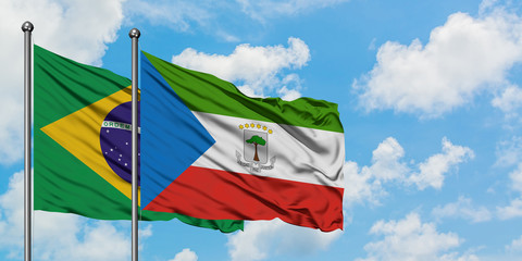 Brazil and Equatorial Guinea flag waving in the wind against white cloudy blue sky together. Diplomacy concept, international relations.