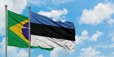 Brazil and Estonia flag waving in the wind against white cloudy blue sky together. Diplomacy concept, international relations.