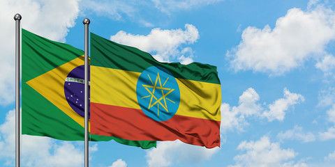 Brazil and Ethiopia flag waving in the wind against white cloudy blue sky together. Diplomacy concept, international relations.