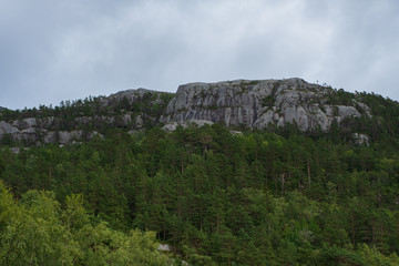 Fototapeta na wymiar Mountains on the way to the Preachers Pulpit Rock in fjord Lysefjord - Norway - nature and travel background. Lake Tjodnane, july 2019