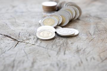 Thai baht money or Money Thai coins staircase sorted on wooden table. King of Thailand. The concept of financial planning, savings, Business successful