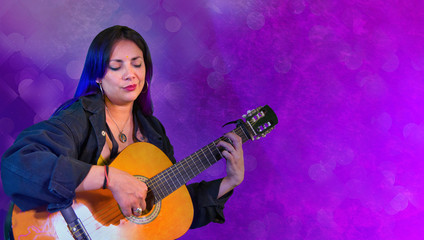 Plakat Woman playing an acoustic guitar in purple background,Latin woman
