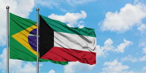 Brazil and Kuwait flag waving in the wind against white cloudy blue sky together. Diplomacy concept, international relations.