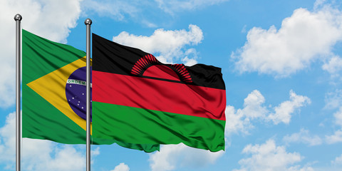 Brazil and Malawi flag waving in the wind against white cloudy blue sky together. Diplomacy concept, international relations.