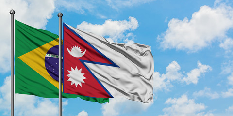 Brazil and Nepal flag waving in the wind against white cloudy blue sky together. Diplomacy concept, international relations.