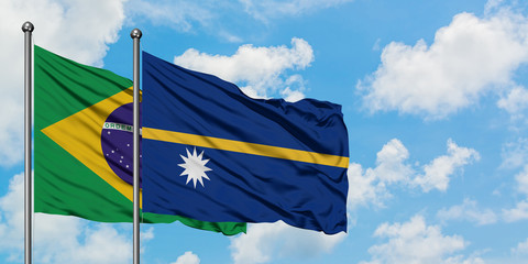 Brazil and Nauru flag waving in the wind against white cloudy blue sky together. Diplomacy concept, international relations.