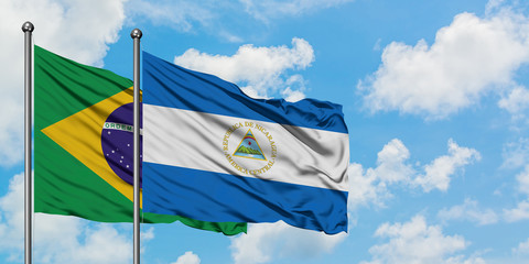 Brazil and Nicaragua flag waving in the wind against white cloudy blue sky together. Diplomacy concept, international relations.