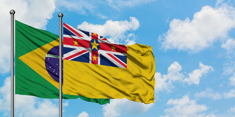 Brazil and Niue flag waving in the wind against white cloudy blue sky together. Diplomacy concept, international relations.