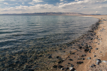 Cloudy sunset on a mountain lake. Mongolia