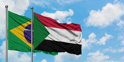 Brazil and Sudan flag waving in the wind against white cloudy blue sky together. Diplomacy concept, international relations.