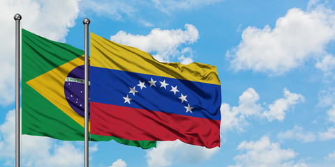 Brazil and Venezuela flag waving in the wind against white cloudy blue sky together. Diplomacy concept, international relations.