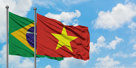 Brazil and Vietnam flag waving in the wind against white cloudy blue sky together. Diplomacy concept, international relations.