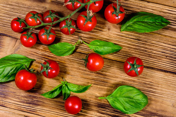 Heap of small cherry tomatoes on wooden table. Top view