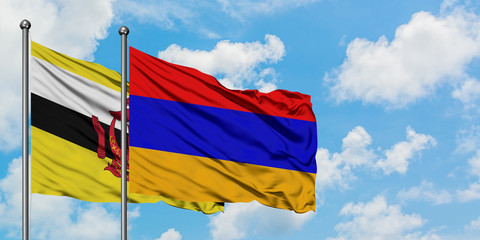 Brunei and Armenia flag waving in the wind against white cloudy blue sky together. Diplomacy concept, international relations.