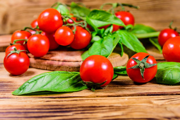 Heap of small cherry tomatoes on wooden table