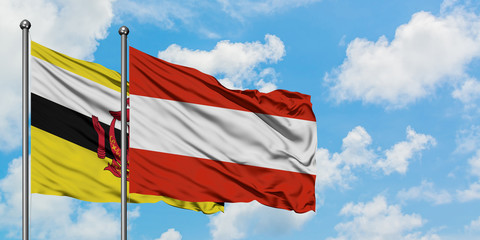 Brunei and Austria flag waving in the wind against white cloudy blue sky together. Diplomacy concept, international relations.