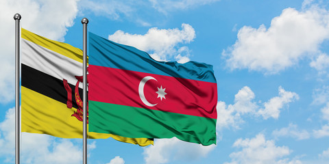 Brunei and Azerbaijan flag waving in the wind against white cloudy blue sky together. Diplomacy concept, international relations.