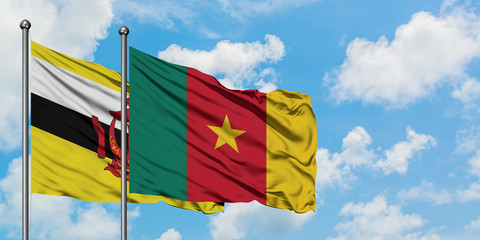 Brunei and Cameroon flag waving in the wind against white cloudy blue sky together. Diplomacy concept, international relations.